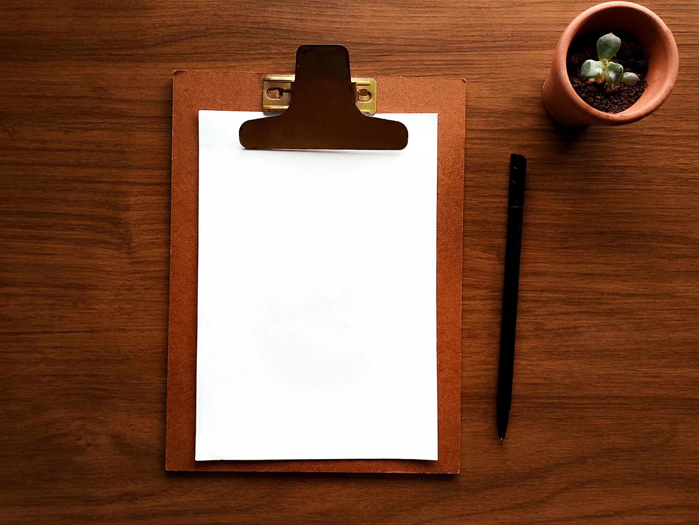 Luxury stationery flatlay with clipboard and pen