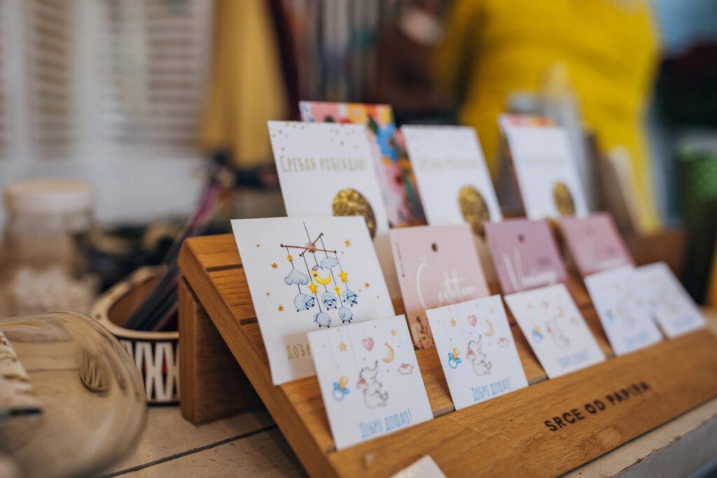 Close-up of greeting cards arranged on a display stand
